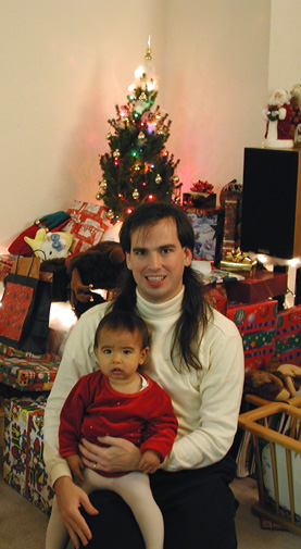 Maya, and Mark by the Christmas tree