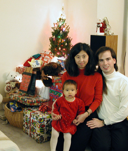 Rebecca, Maya, and Mark by the Christmas tree